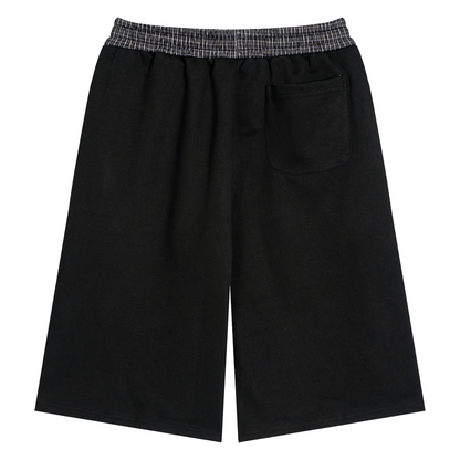 Black unisex shorts with plaid elastic waistband, drawcords, and front pocket