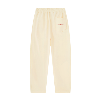 Light apricot unisex tapered straight hem sweatpants, elastic waist, small logo label on front pocket