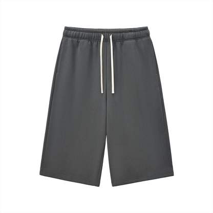 Charcoal gray relaxed three-quarter sweatpants with elastic waistband and white drawstring