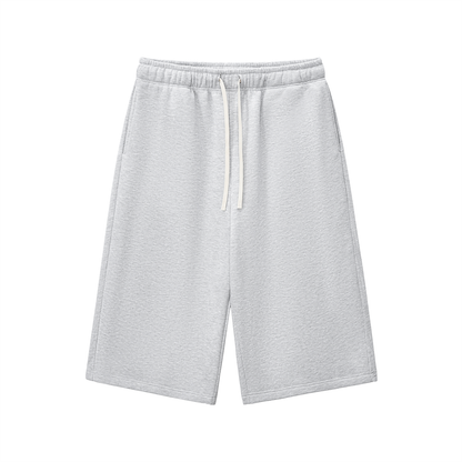 Light gray three-quarter sweatpants with elastic waistband and drawstring, relaxed fit