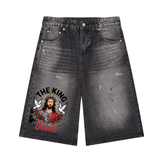 Black wide-leg denim shorts with vintage wash and Jesus graphic on panels