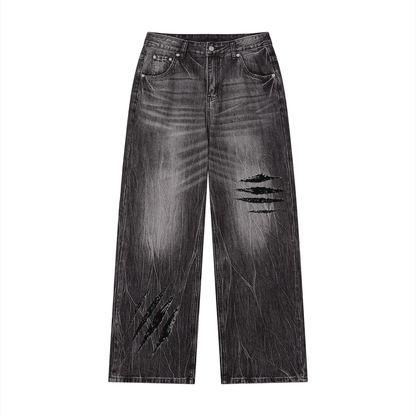 Black vintage-wash wide-leg jeans with distressed slash patches on front legs