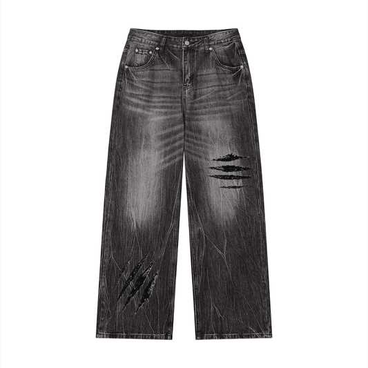 Black vintage-wash wide-leg jeans with distressed slash patches on front legs
