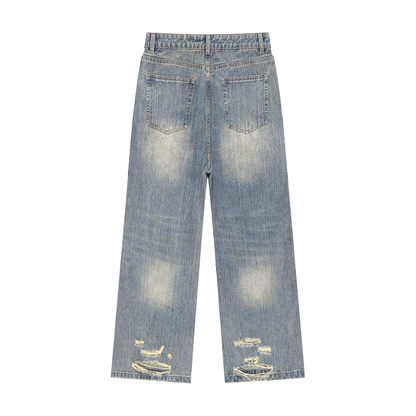 Distressed blue wash denim jeans, back view, with back pockets and frayed hem rips