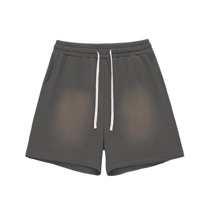 Dark gray cotton shorts with elastic waistband, drawstring, raw hem, sun-fade distress.