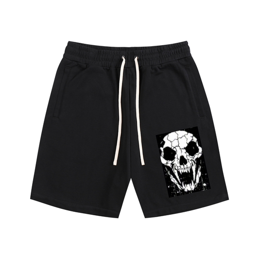 Black cotton shorts with elastic waistband, drawstring, side pockets, and skull front graphic.