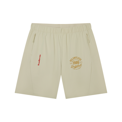 Light beige basketball shorts with drawstring waist, side pockets, and logo patch