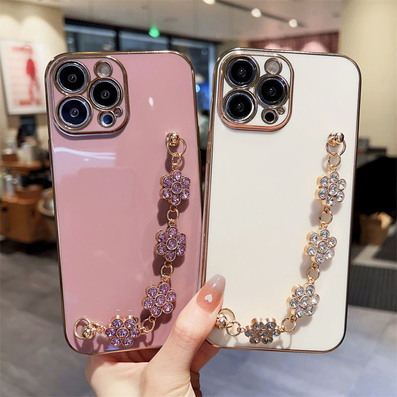 Rhinestone wrist bracelet phone case strap with purple floral chain on pink and white cases