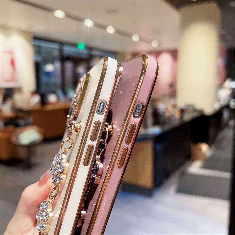 Three stacked phone cases showing rhinestone bracelet chain details along the sides.