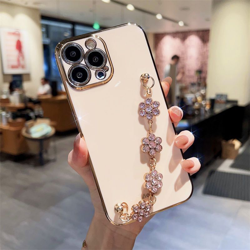 Cream phone case with purple rhinestone bracelet chain strap
