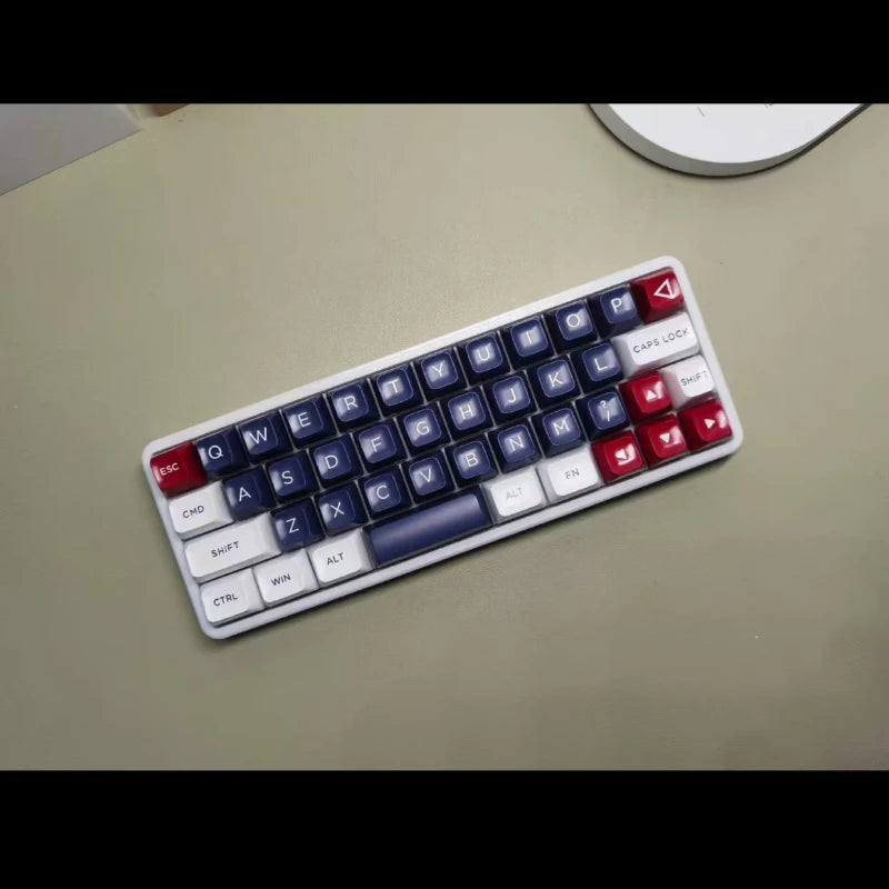 40% hot-swappable mechanical keyboard angled, blue keycaps with red and white accent keys