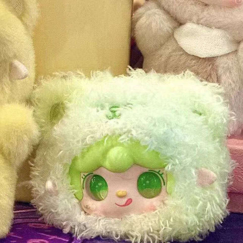 Light green plush character with big eyes nestled among other plush items
