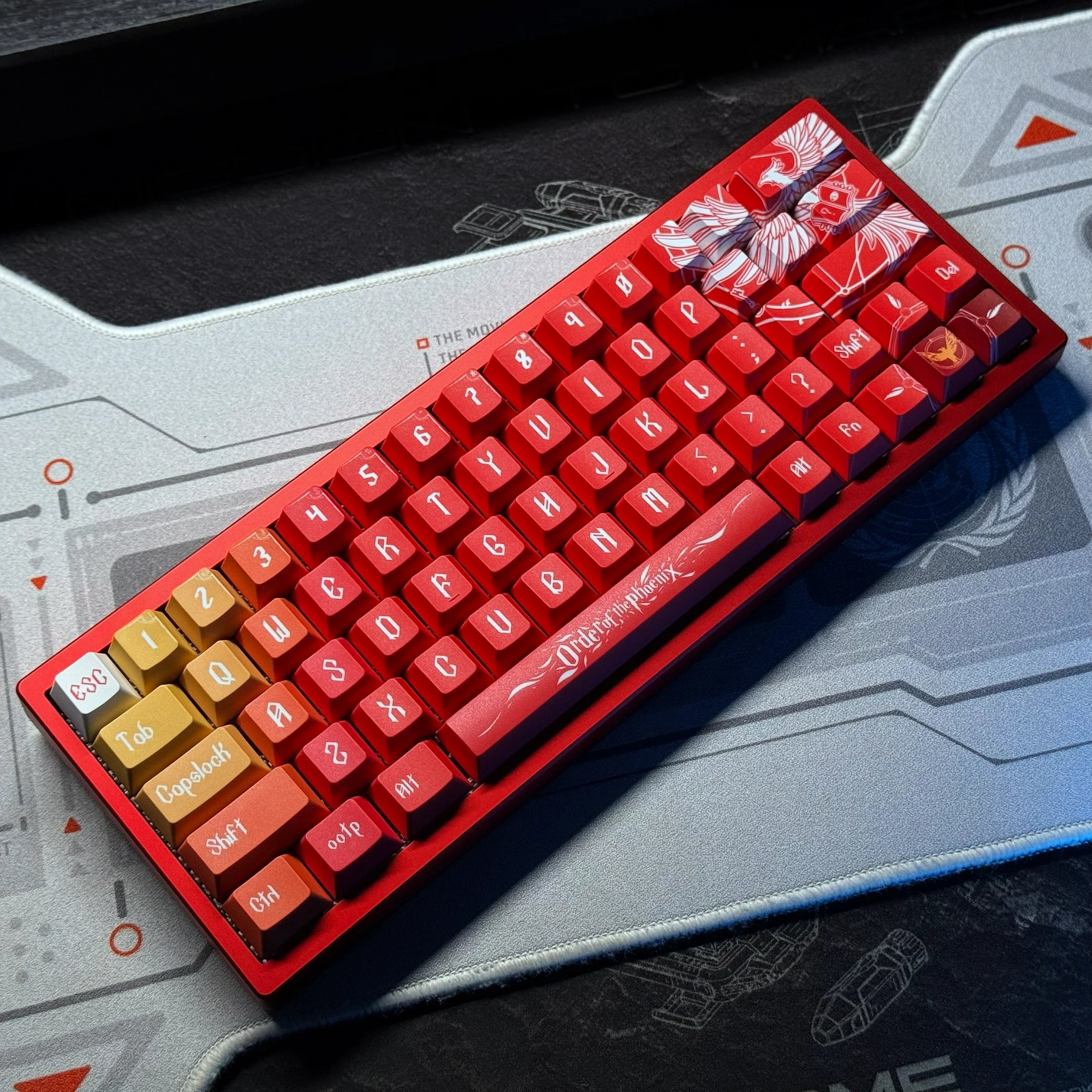 Red keyboard PCB kit with red keycaps and gold accents, with a clear overlay