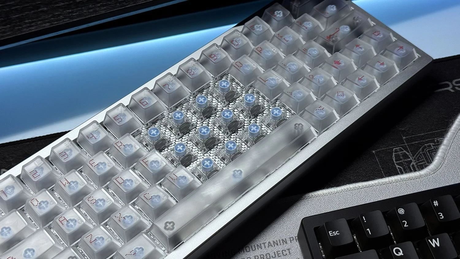 RGB keyboard PCB kit with clear switch housings and glowing blue LEDs