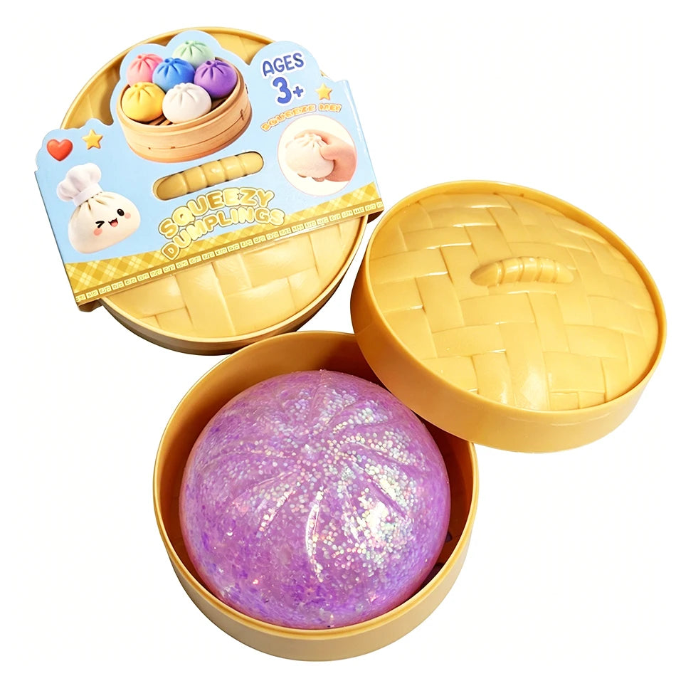 Dumpling squishy fidget toy with purple glittery ball in yellow tray, lid open