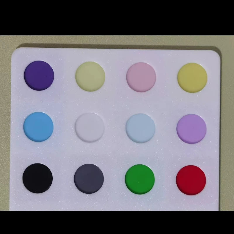 Assorted round keycaps in purple, green, pink, yellow, blue, black, and red