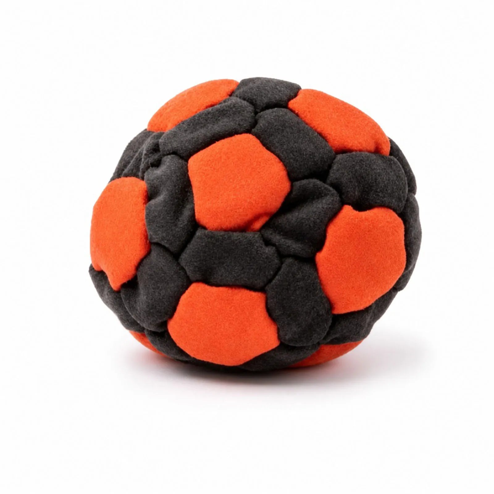 Black and orange plush footbag ball with padded patch design, soft fuzzy texture.