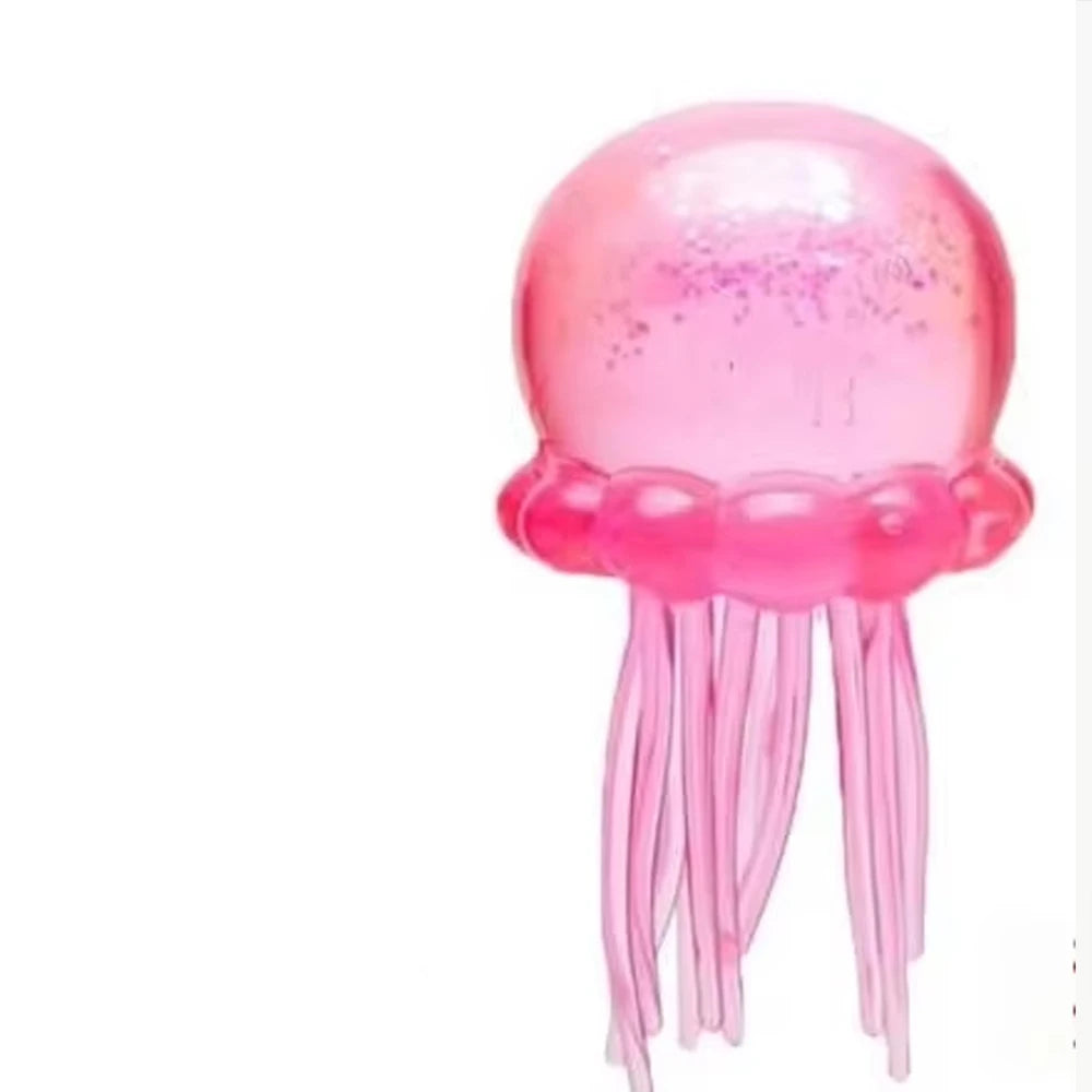 Pink squishy jelly stress toy with dome top and hanging tentacle strands.