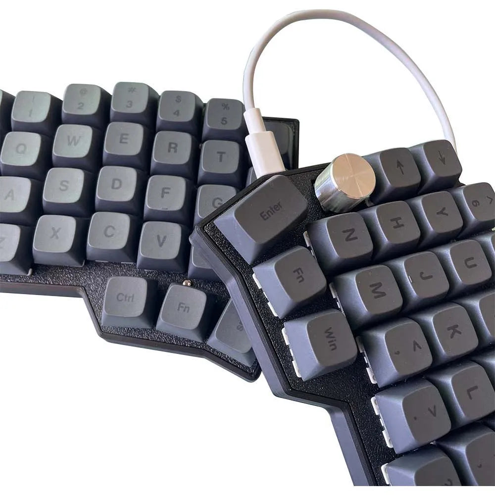 Close-up of Corne 4x6 split keyboard keycaps with rotary knob and connected cable