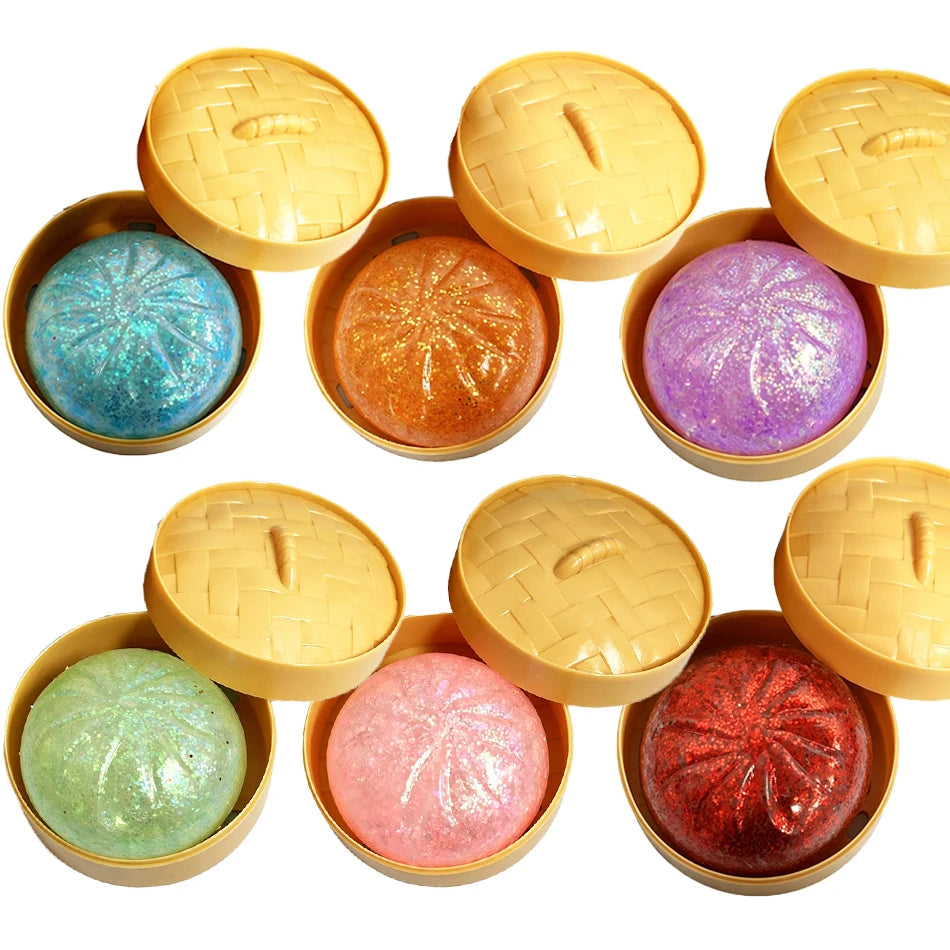 Assorted dumpling squishy stress toys with glitter fillings in yellow tops