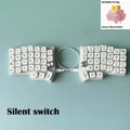 Split ergonomic keyboard with white keycaps and two knob modules for silent switches