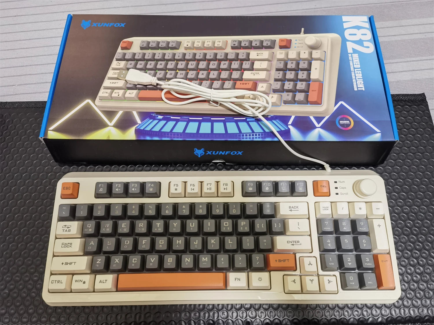 Wired keyboard with cream and black keys, orange accents, RGB backlight, volume knob