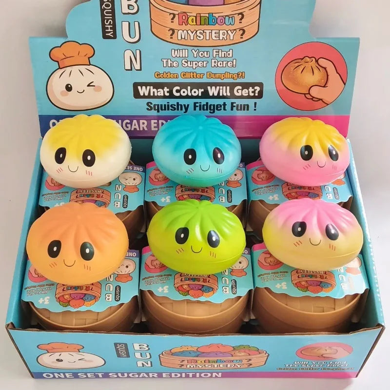 Colorful dumpling squishy fidget ball ornaments in a retail display box, assorted faces