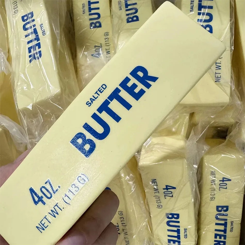 Yellow butter-stick squishy toy close-up, angled view with 4oz 113g salted label
