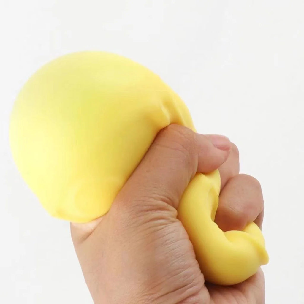 Yellow cheese-shaped squishy toy held in hands, soft textured holes