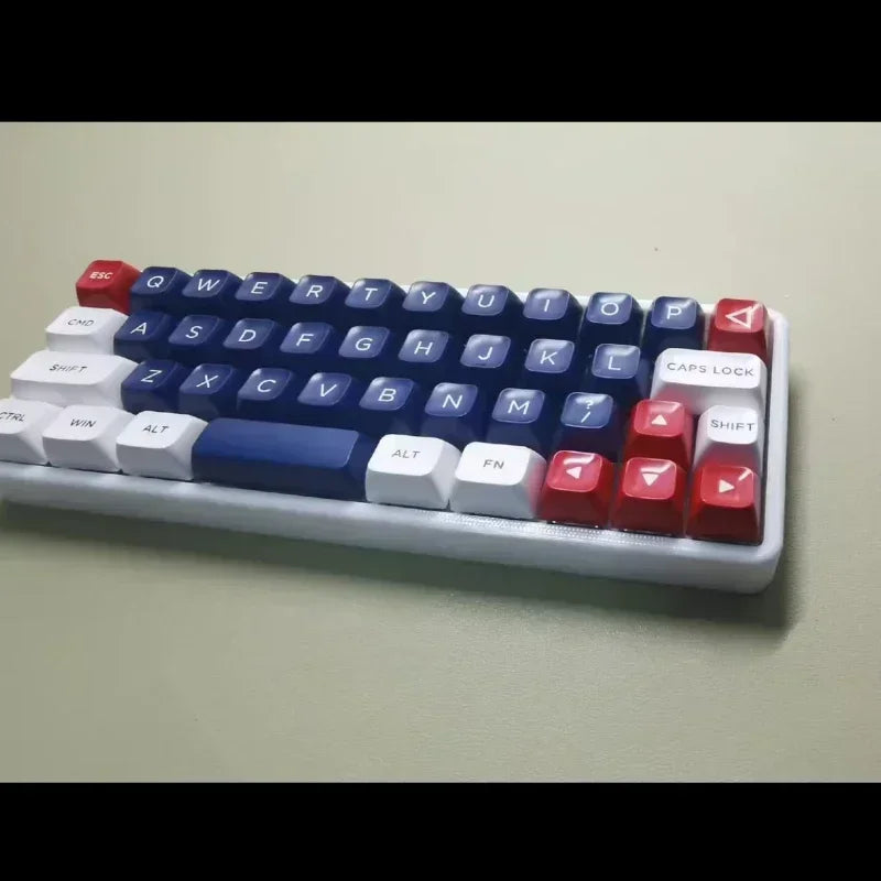 Close side view of a 40% mechanical keyboard with blue keycaps and red modifier keys
