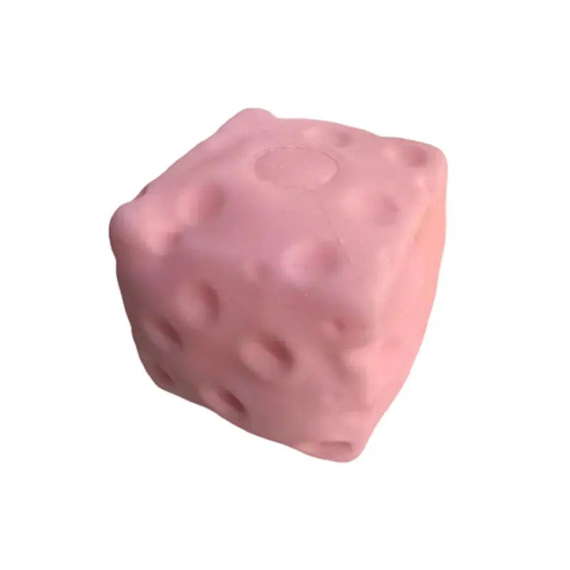 Pink cheese-shaped squishy toy block with dimpled holes