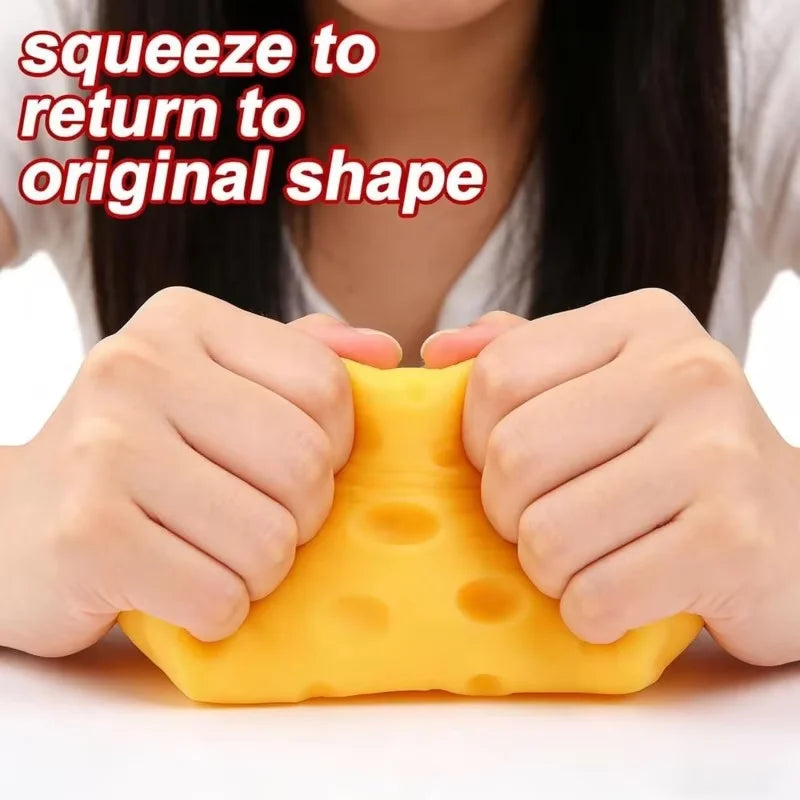 Yellow cheese-shaped squishy toy being squeezed to return to original shape