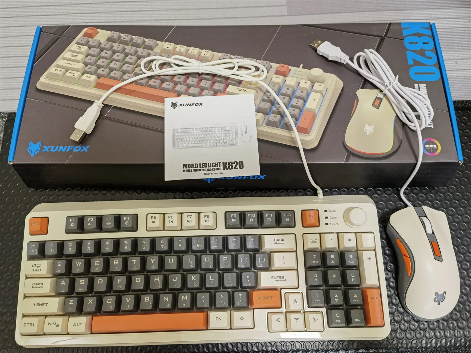 Wired keyboard with cream and black keycaps, orange accents, and included cables