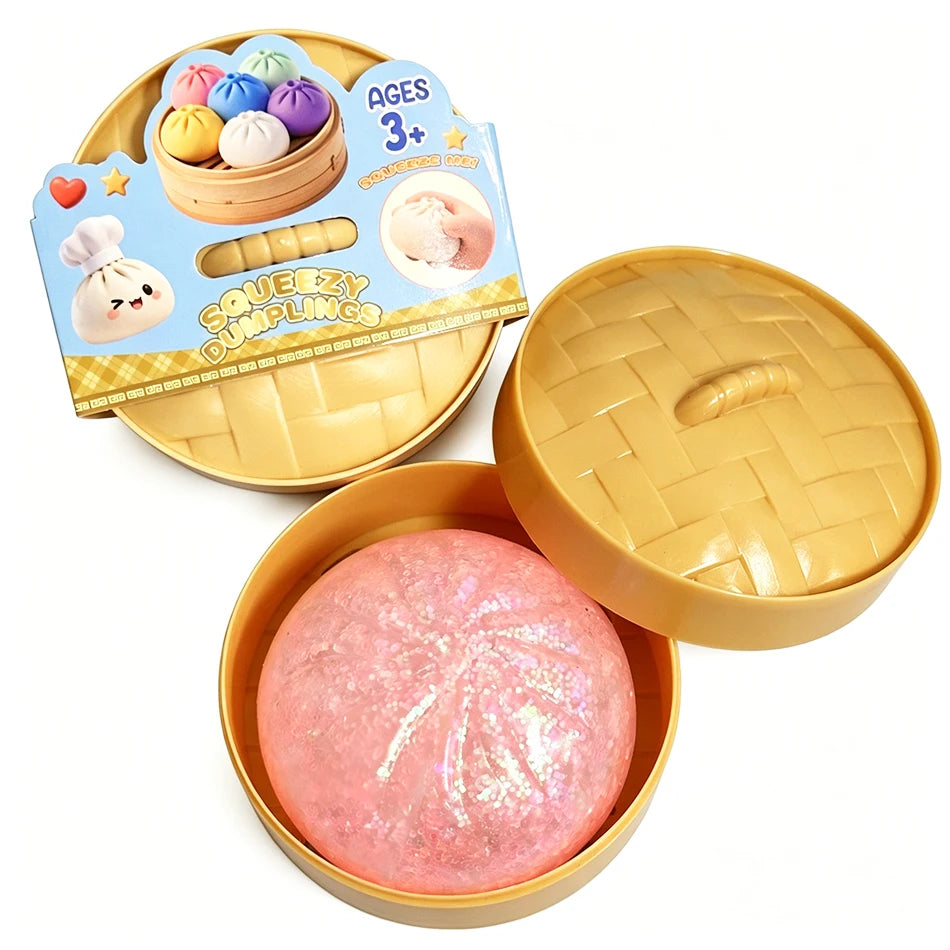 Dumpling squishy fidget toy with pink glittery ball in yellow tray, lid open