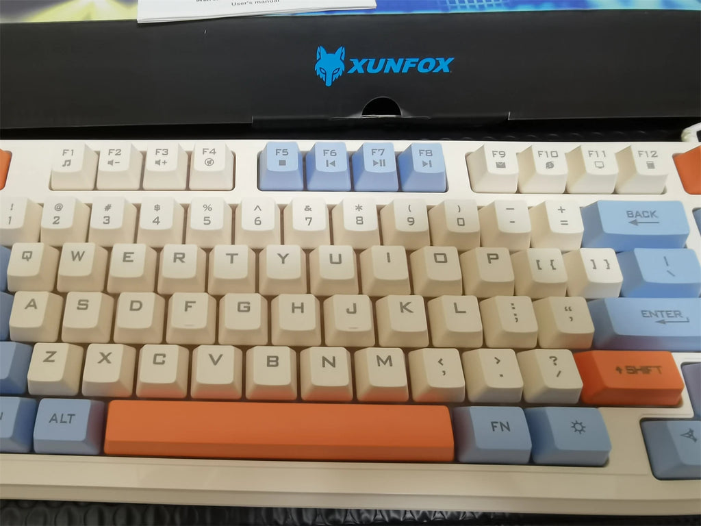 Close-up of 94-key wired RGB keyboard with beige, orange, and light-blue accent keycaps