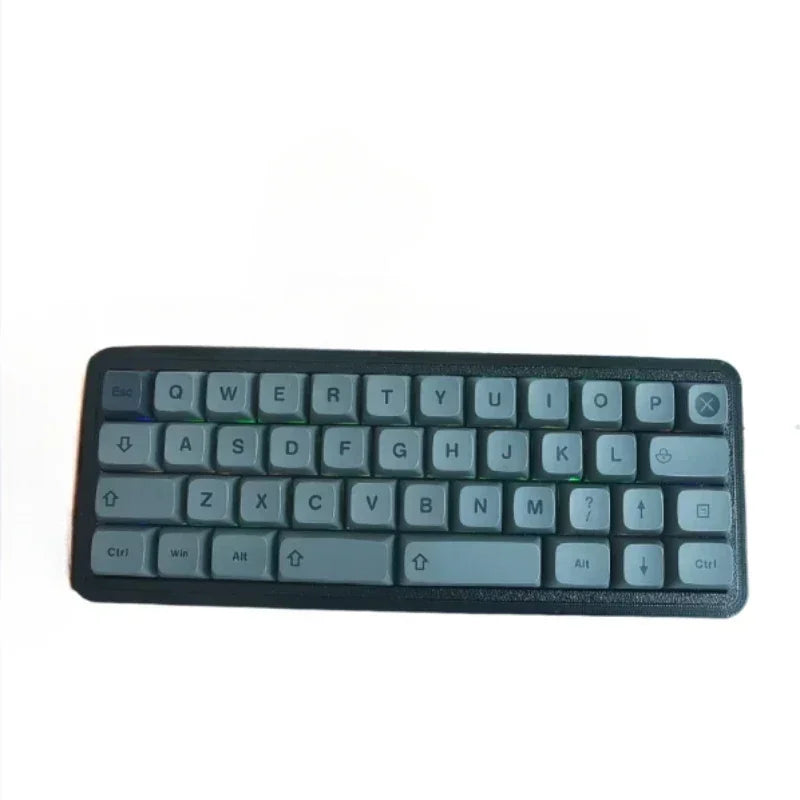 40% hot-swappable mechanical keyboard, dark teal base with gray/teal keycaps.