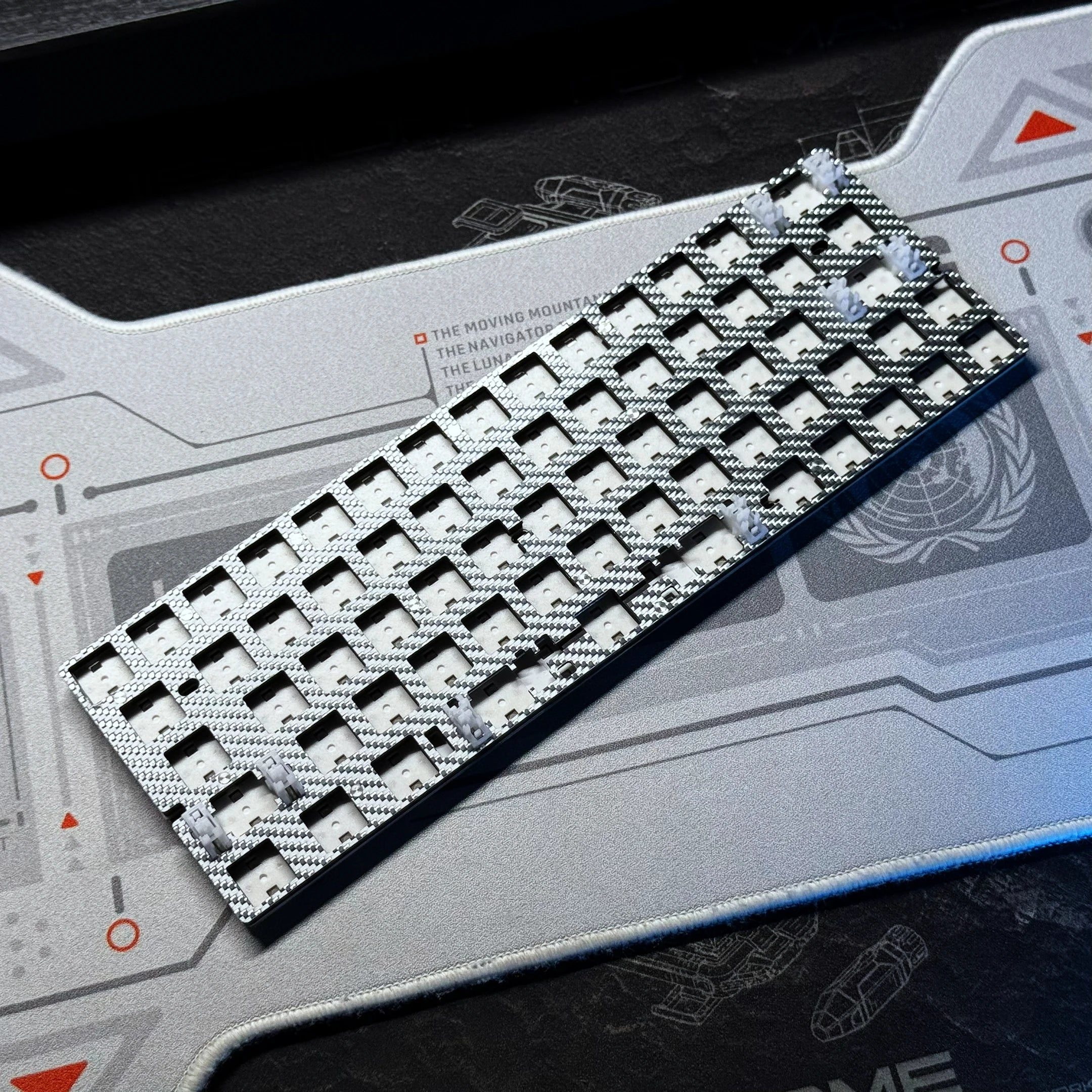 White keyboard PCB kit with black-and-white keycaps and grid layout