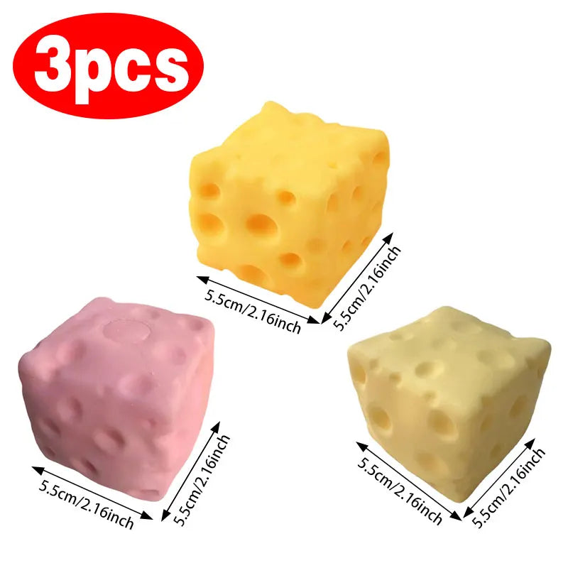 Set of three cheese-shaped squishy toys in yellow and pink tones