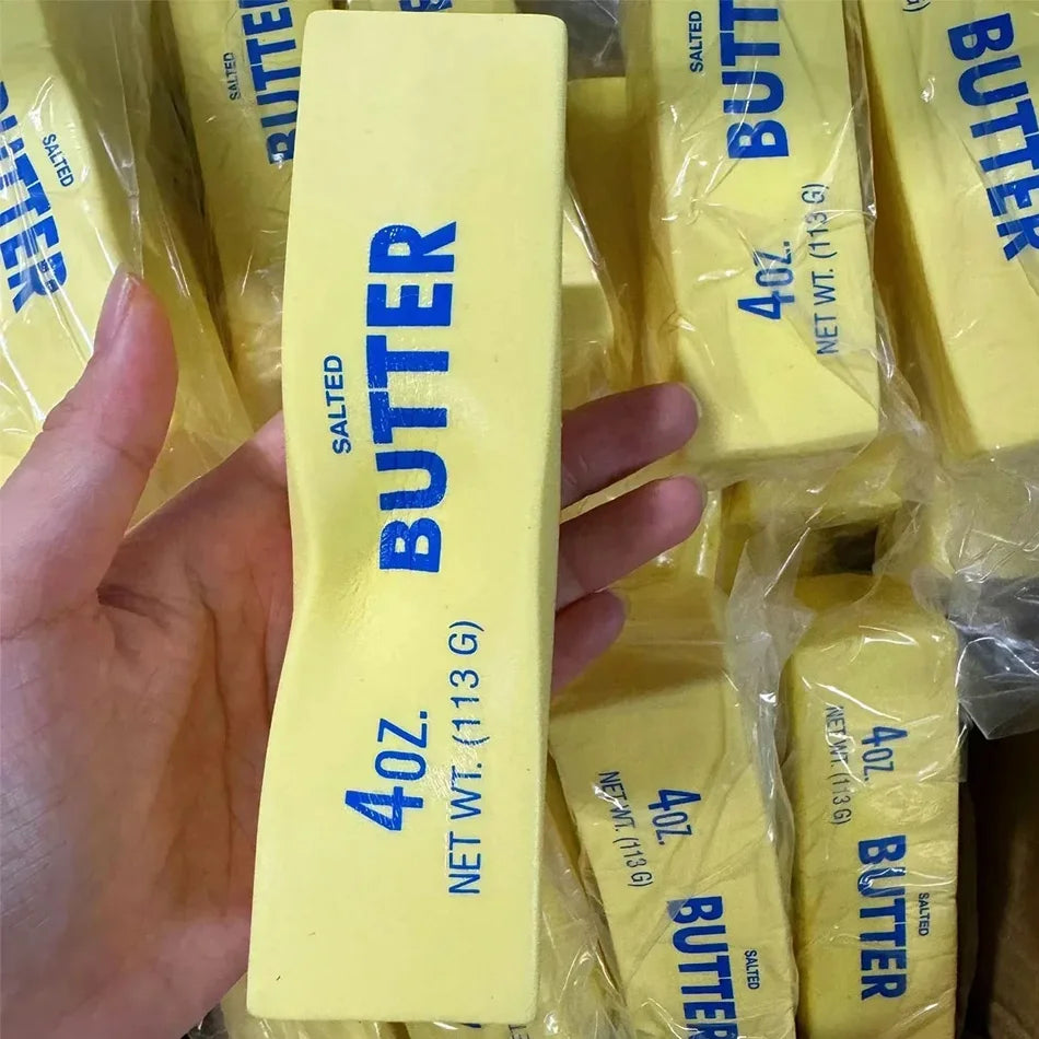 Yellow butter-stick squishy toy, hand holding 4oz 113g salted butter label