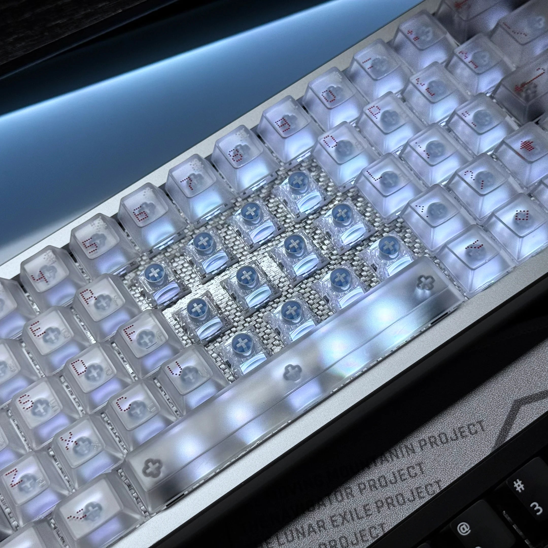 White keyboard LED plate with a grid of clear sockets and blue-lit components