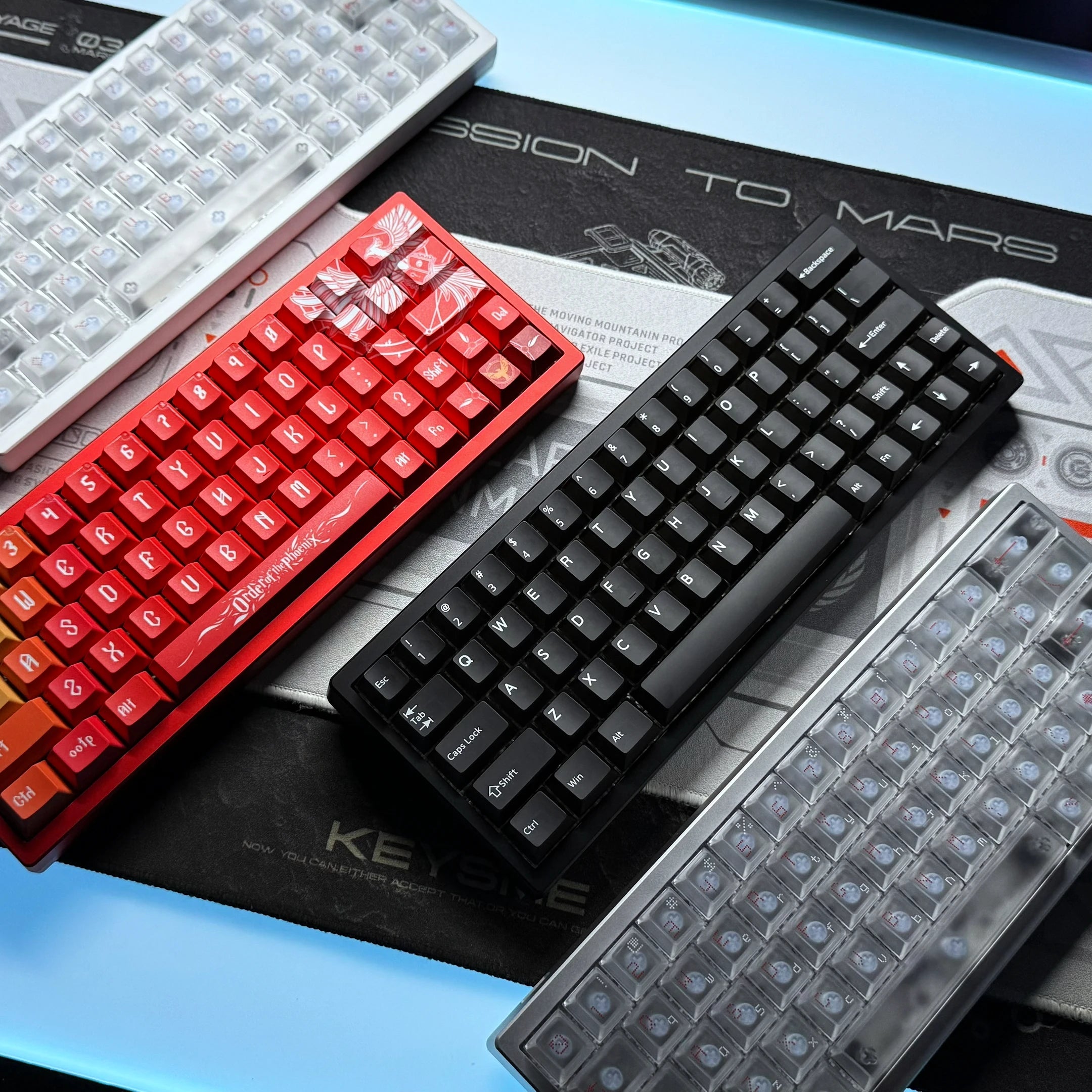 Red and black keyboards with a clear LED PCB plate showing translucent switch caps