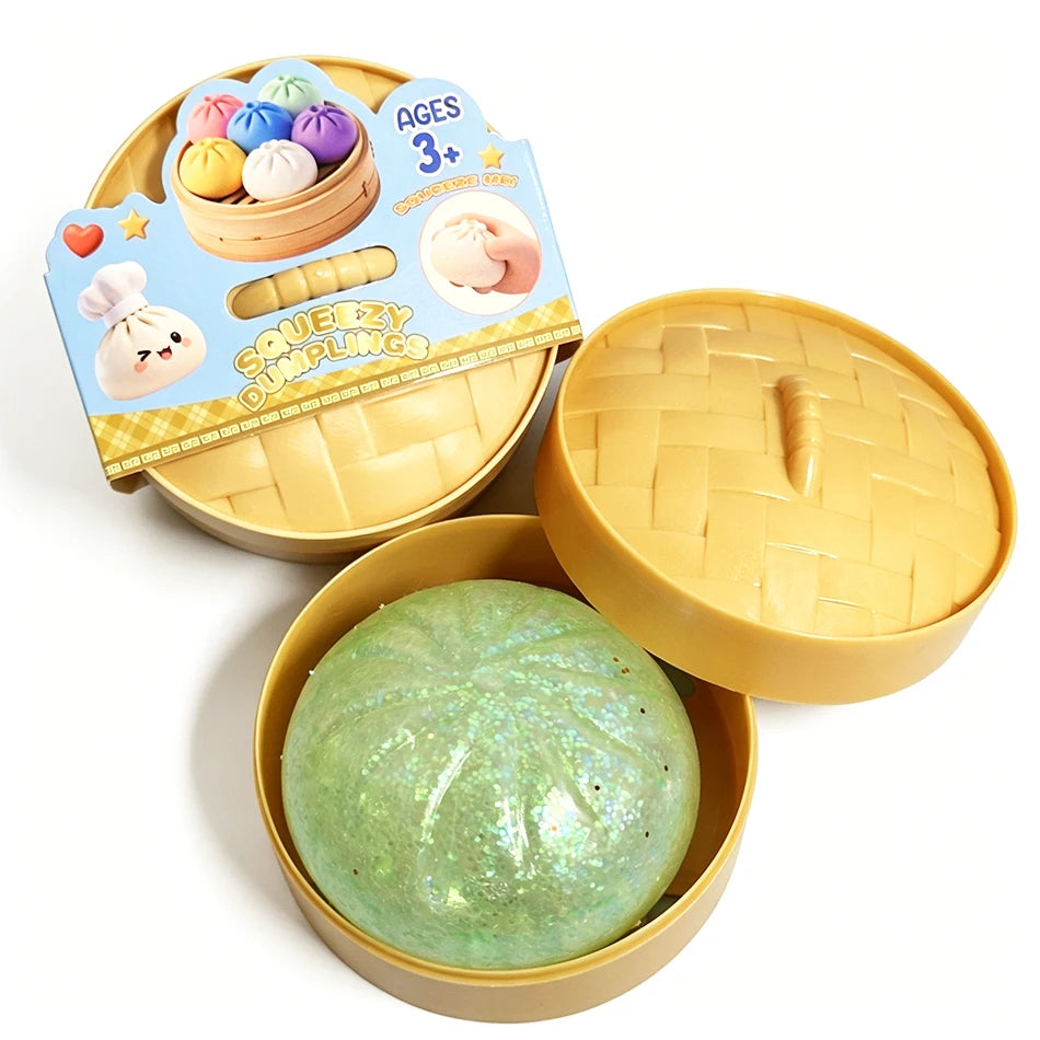 Dumpling squishy fidget toy with green glittery ball in yellow tray, lid open