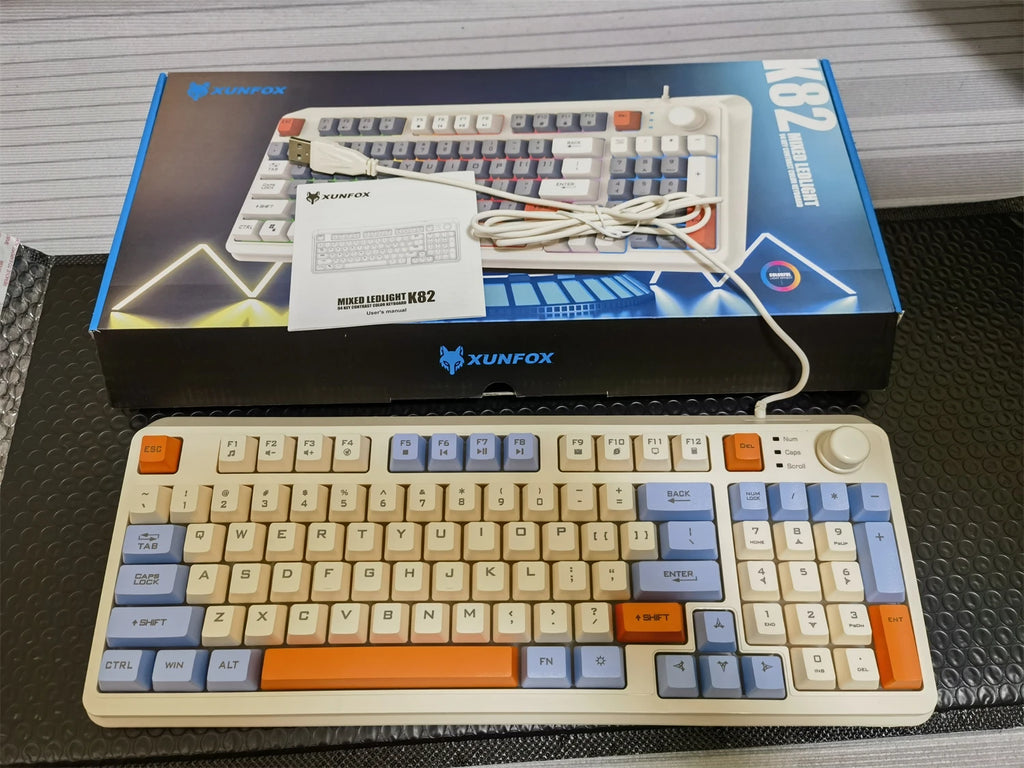 94-key wired RGB keyboard in retail box with cable and beige keycaps with orange accents