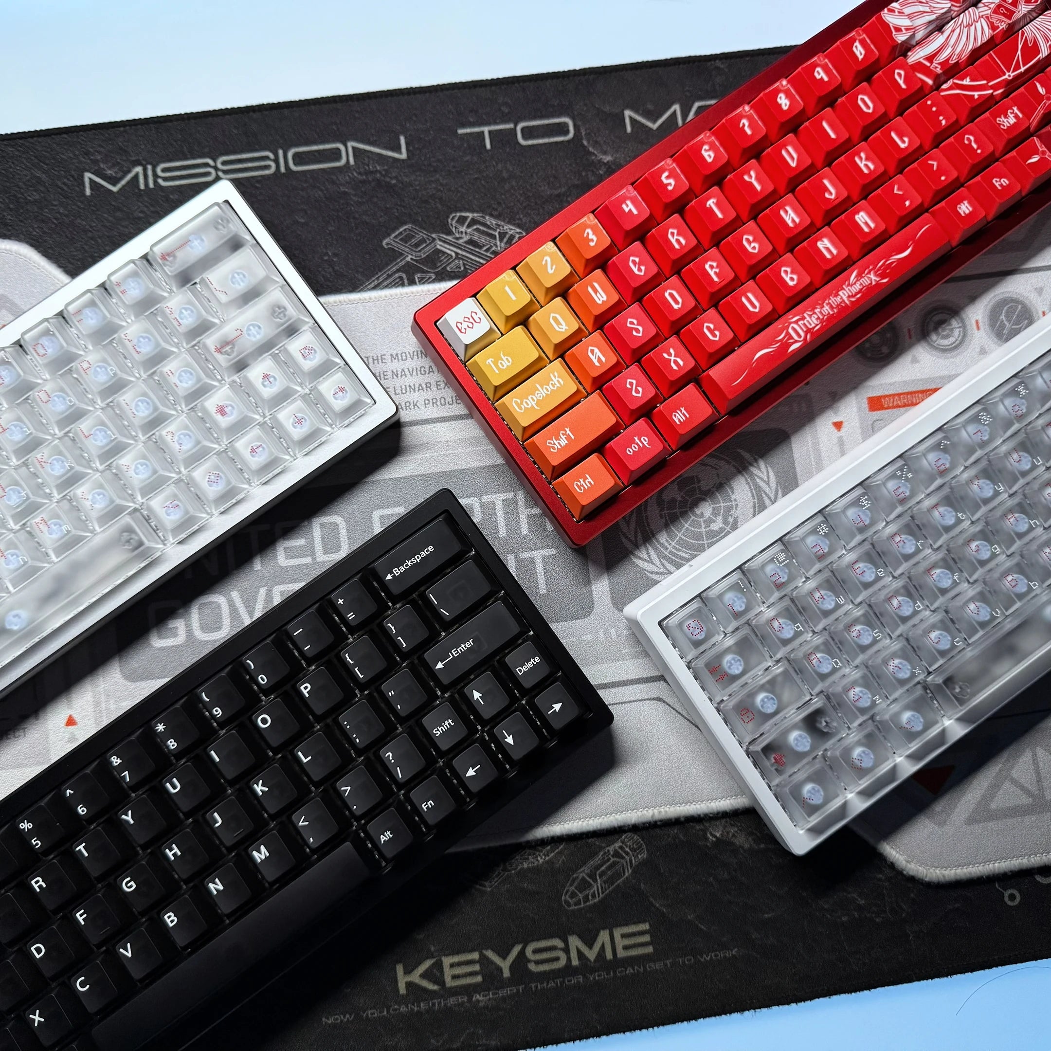 Red keyboard with orange keycaps shown with clear LED plate and black keyboard