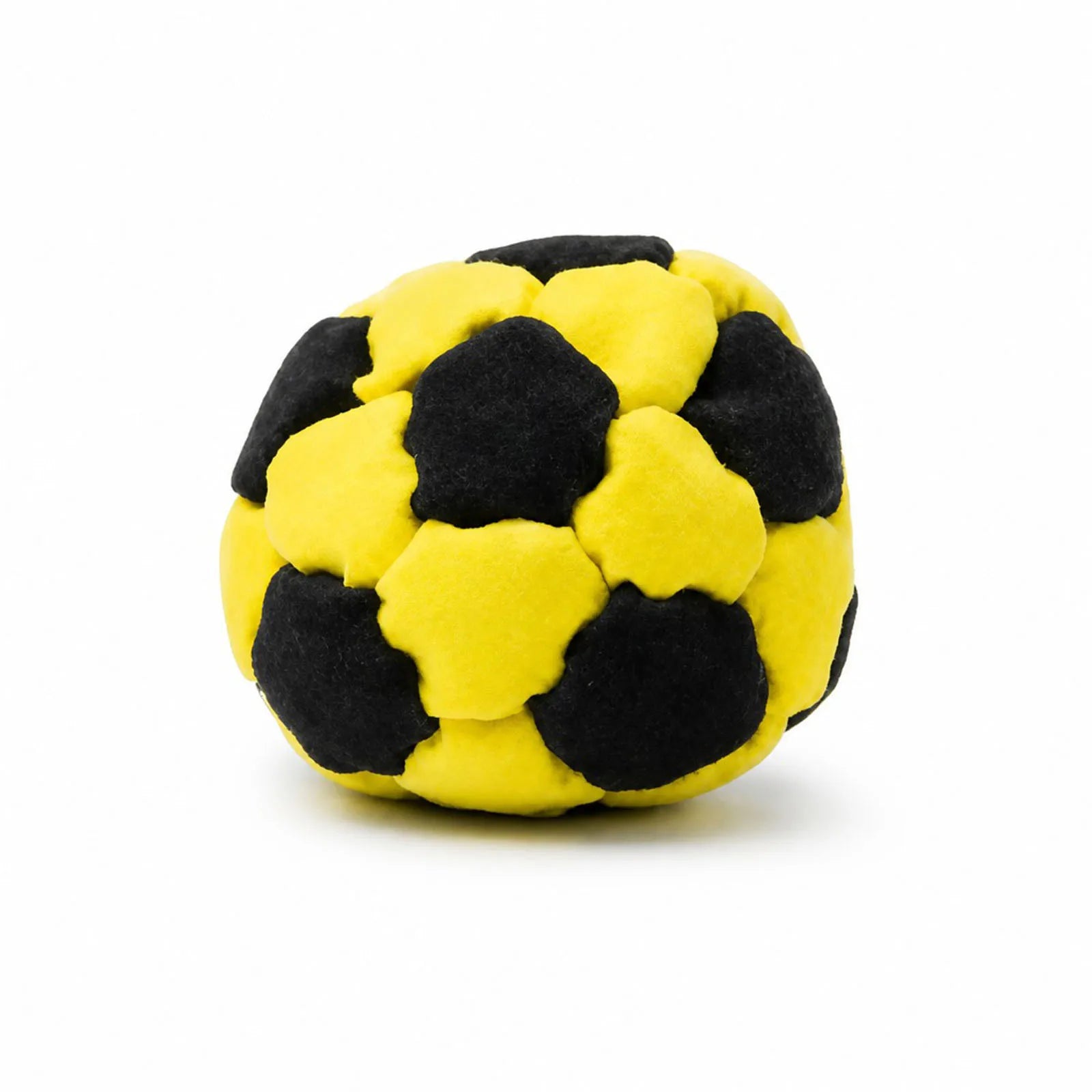 Yellow and black plush footbag ball with rounded patch sections, soft fuzzy texture.