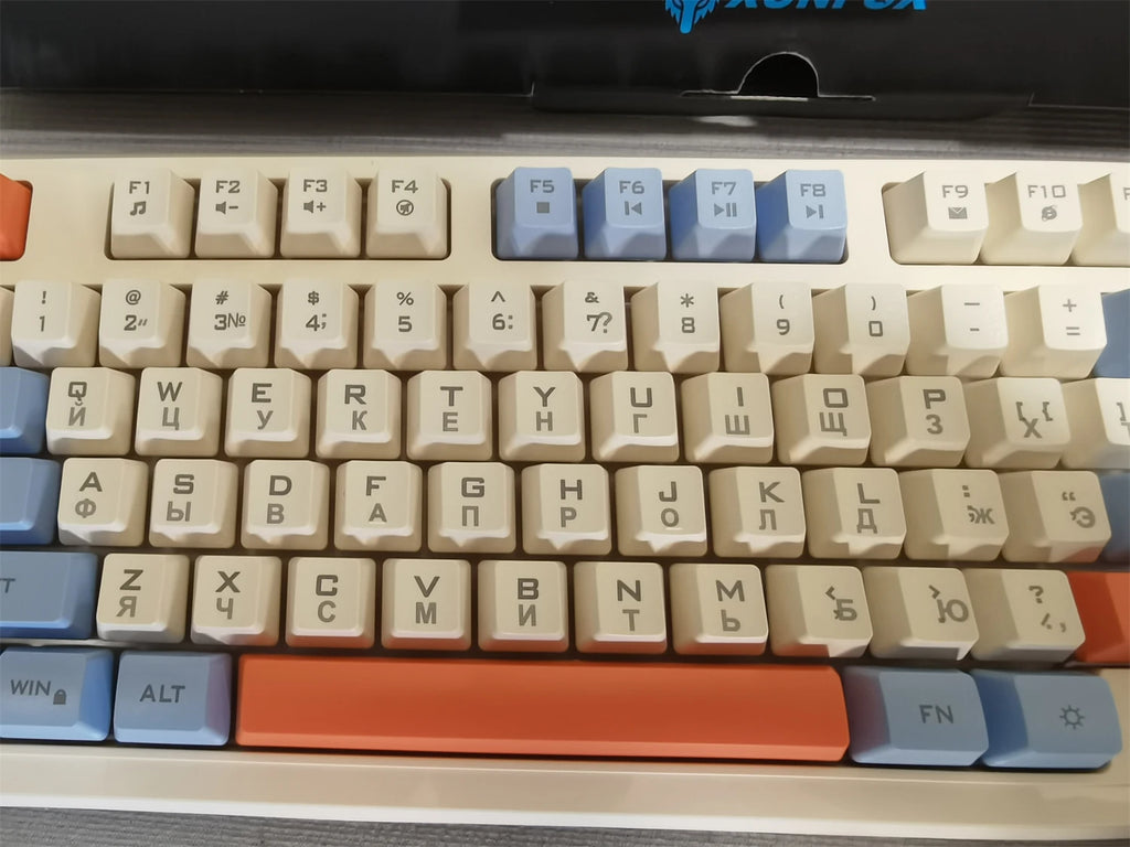 XUNFOX key close-up: beige, gray, and black keys with orange bar and FN key