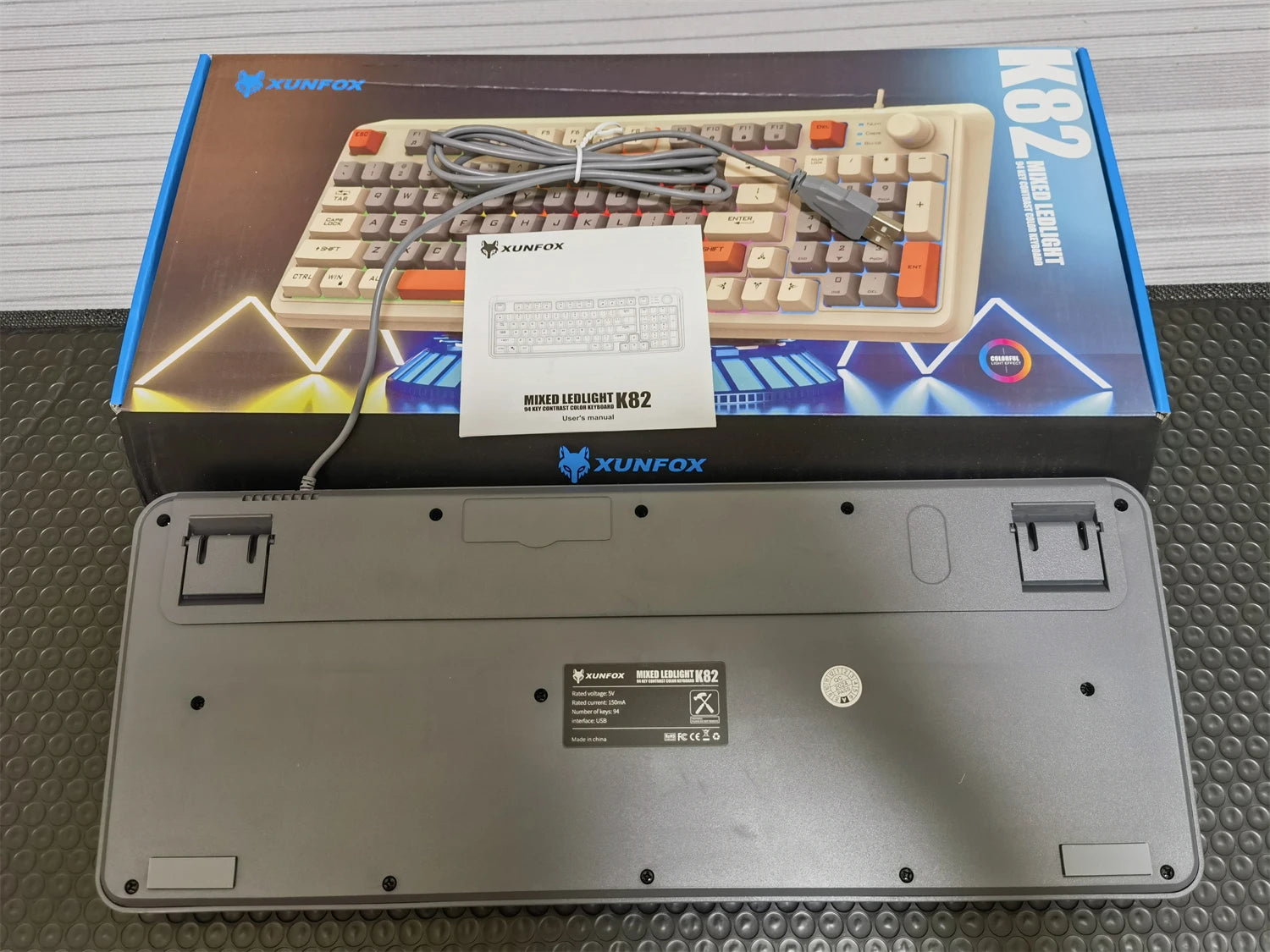 Bottom view of 94-key mechanical keyboard showing mounting feet, ports, and label