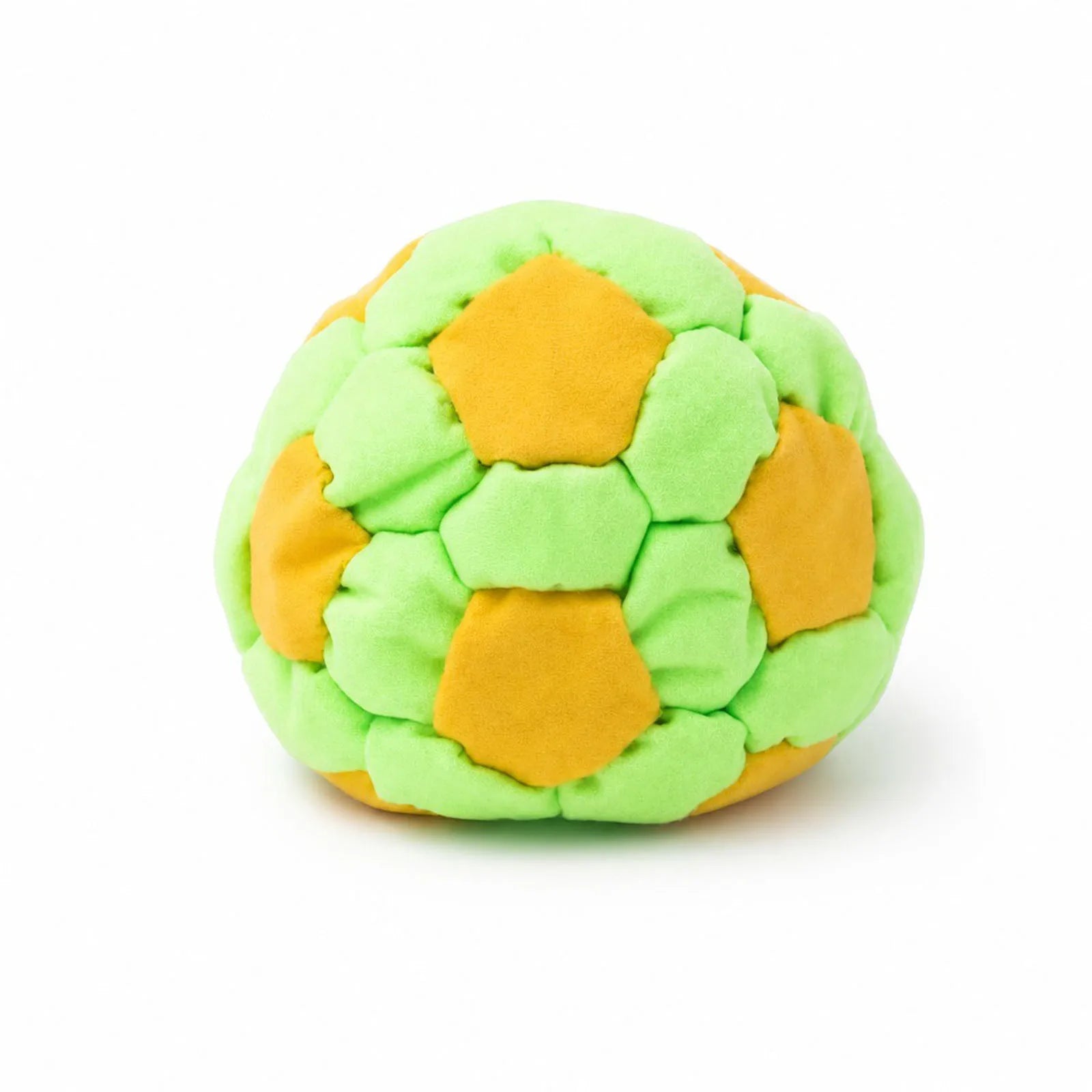Green and yellow plush footbag ball with hex patch panels, soft fuzzy fabric.