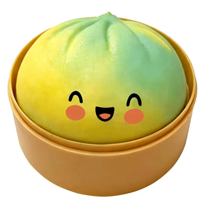 Green dumpling squishy fidget ball with cute face inside round gold tin