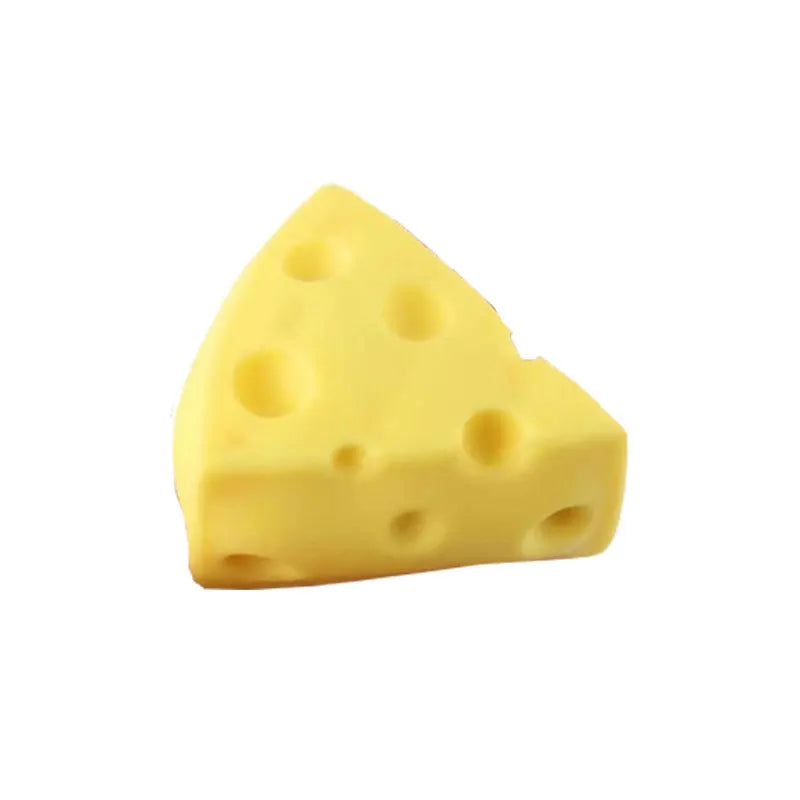 Triangle yellow cheese squishy toy with multiple round holes on the front face.